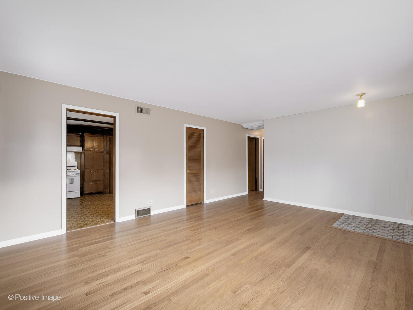 5102 Butterfield Road Hillside, IL 60162 - Photo 5 of 22 a view of an empty room with wooden floor and closet