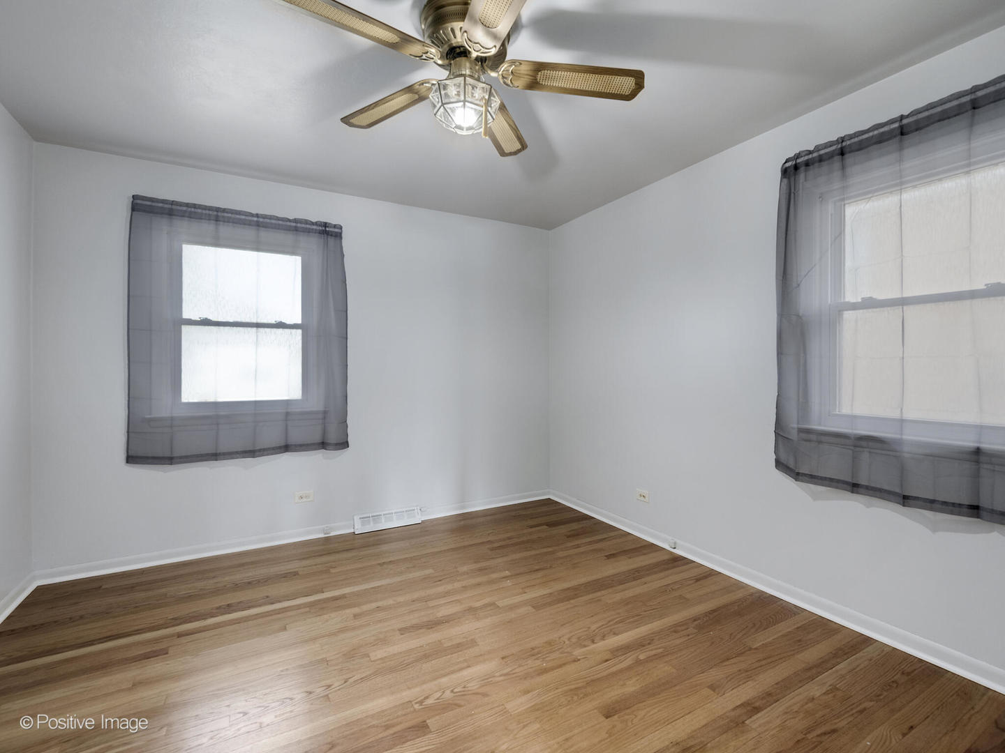 5102 Butterfield Road Hillside, IL 60162 - Photo 10 of 22 a view of empty room with wooden floor and fan