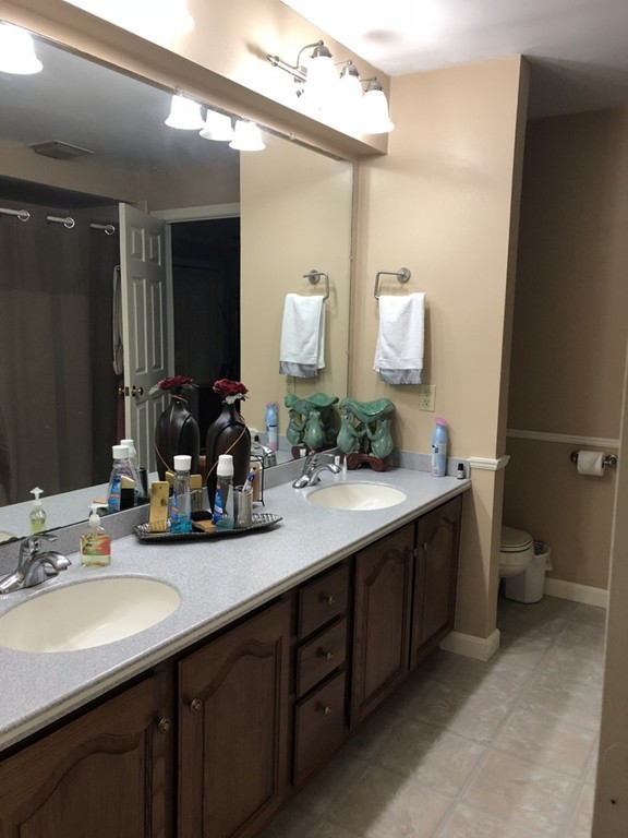 107 Center Depot Road, Unit F Charlton, MA 01507 - Photo 16 of 20 a bathroom with a double vanity sink and a mirror