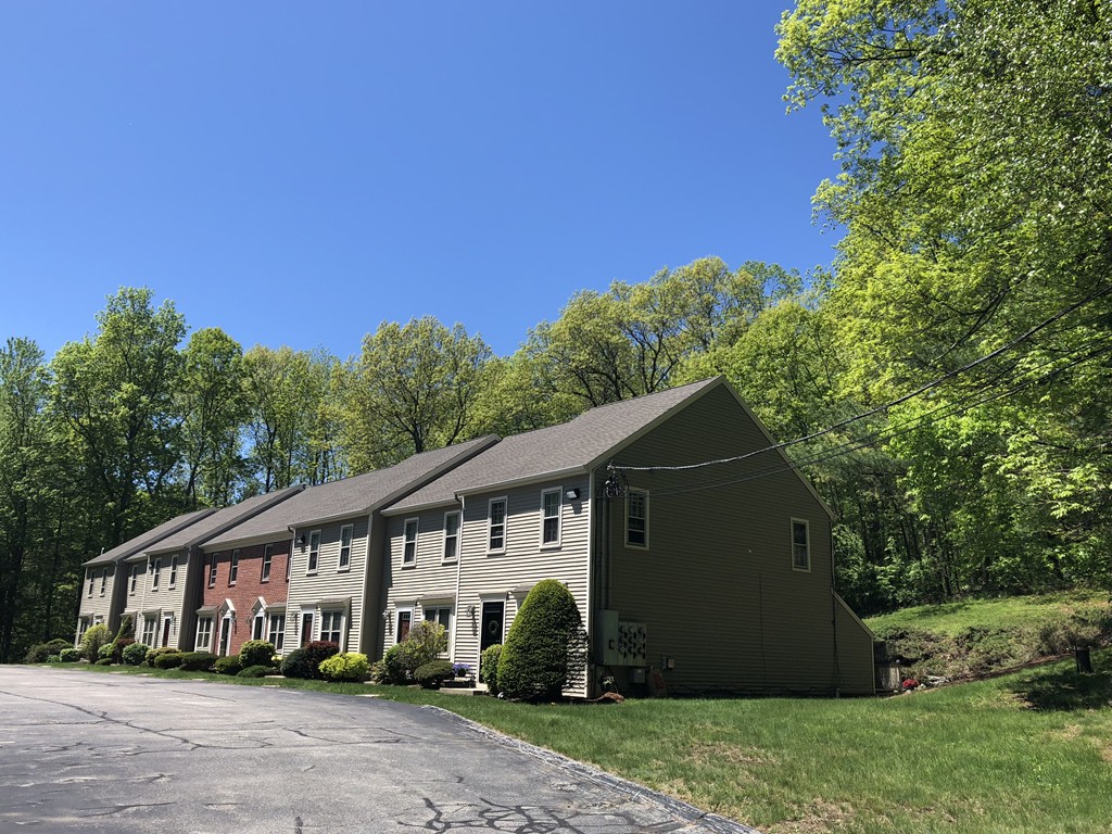 107 Center Depot Road, Unit F Charlton, MA 01507 - Photo 2 of 20 a view of a house with a yard plants and large tree