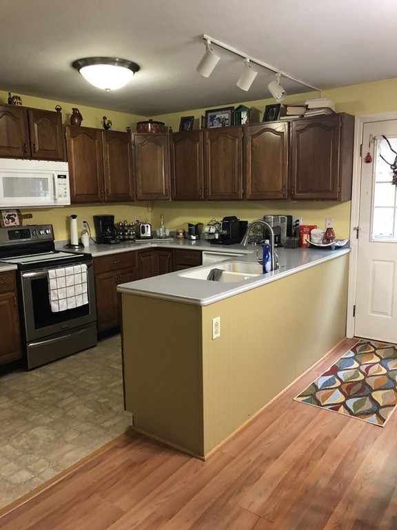 107 Center Depot Road, Unit F Charlton, MA 01507 - Photo 5 of 20 a kitchen with stainless steel appliances granite countertop a stove a sink and a refrigerator