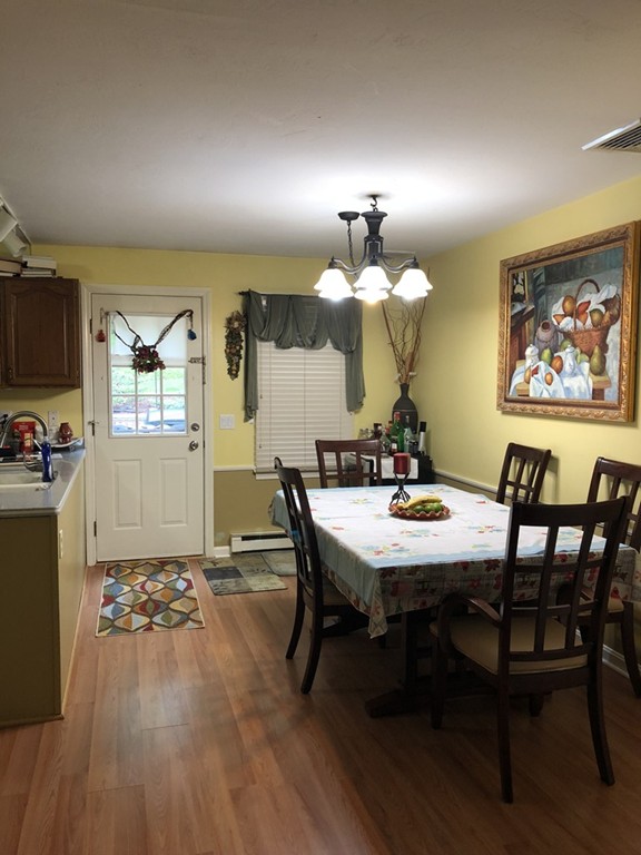 107 Center Depot Road, Unit F Charlton, MA 01507 - Photo 7 of 20 a view of a dining room with furniture and wooden floor