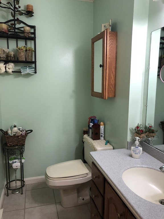 107 Center Depot Road, Unit F Charlton, MA 01507 - Photo 10 of 20 a bathroom with a toilet a sink and mirror