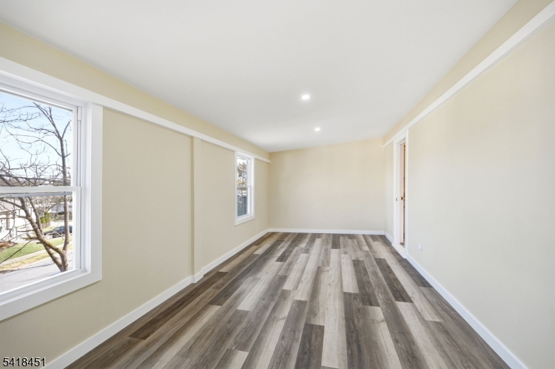 61 Hemlock Road Rockaway, NJ 07866 - Photo 11 of 40 a view of empty room with wooden floor and fan
