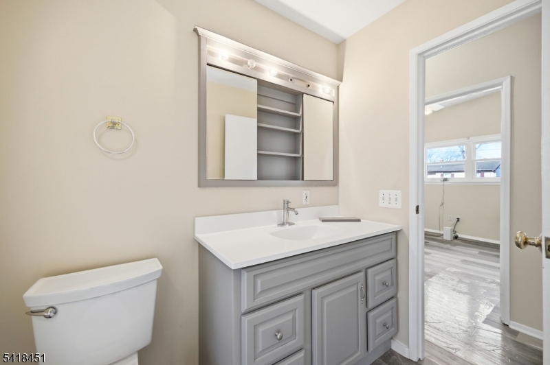 61 Hemlock Road Rockaway, NJ 07866 - Photo 12 of 40 a bathroom with a toilet sink and mirror