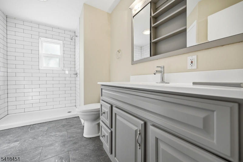 61 Hemlock Road Rockaway, NJ 07866 - Photo 13 of 40 a bathroom with a sink a toilet and shower