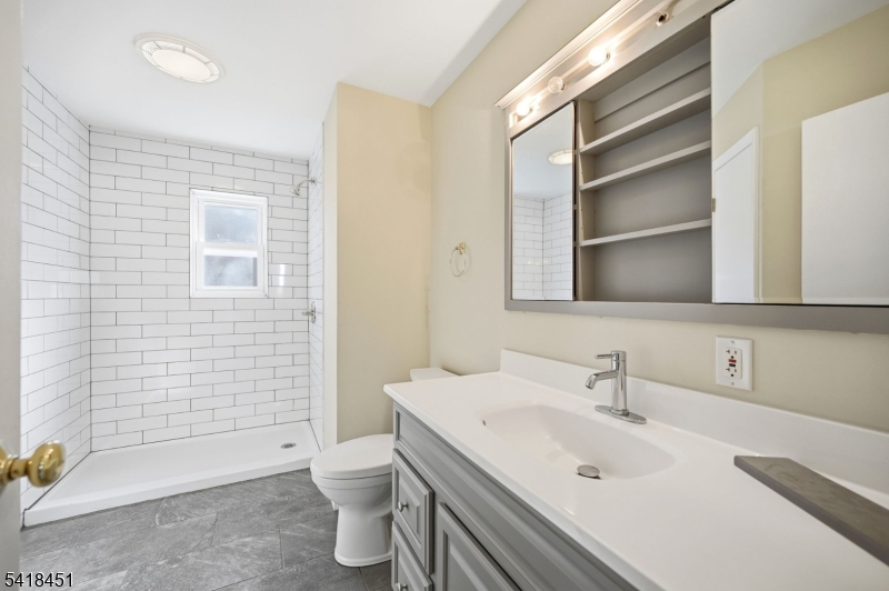 61 Hemlock Road Rockaway, NJ 07866 - Photo 14 of 40 a bathroom with a sink toilet and shower