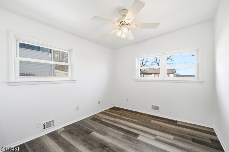 61 Hemlock Road Rockaway, NJ 07866 - Photo 16 of 40 a view of a room with wooden floor and ceiling fan