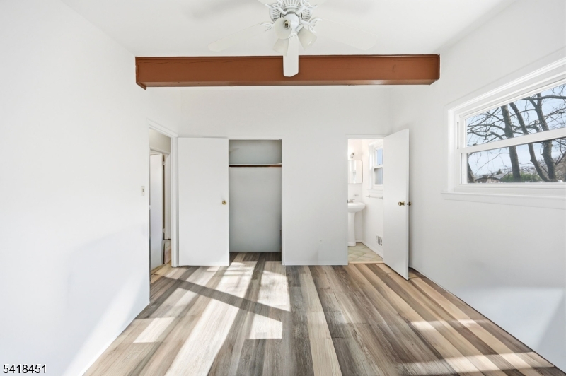 61 Hemlock Road Rockaway, NJ 07866 - Photo 18 of 40 a view of a room with wooden floor and a ceiling fan