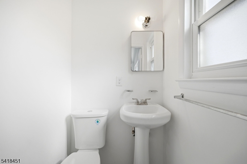 61 Hemlock Road Rockaway, NJ 07866 - Photo 19 of 40 a bathroom with a sink toilet and mirror