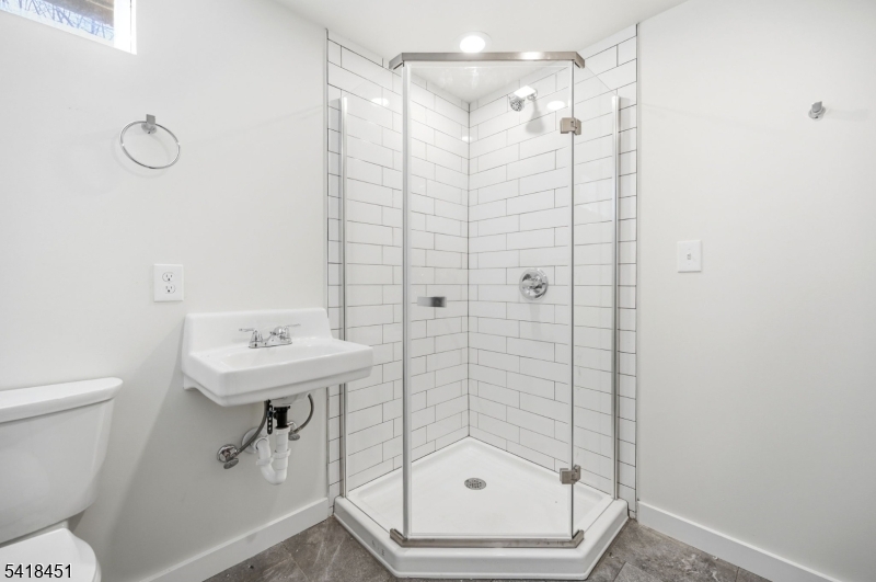 61 Hemlock Road Rockaway, NJ 07866 - Photo 23 of 40 a bathroom with a shower a toilet and a sink