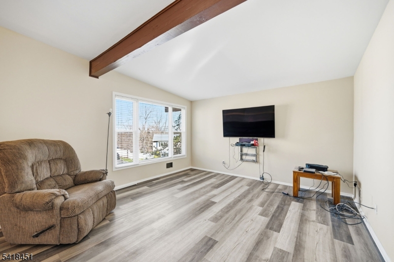 61 Hemlock Road Rockaway, NJ 07866 - Photo 4 of 40 a living room with furniture and a flat screen tv