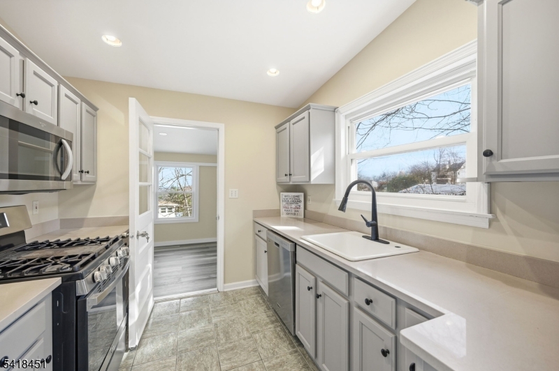 61 Hemlock Road Rockaway, NJ 07866 - Photo 8 of 40 a kitchen with stainless steel appliances granite countertop a sink and a stove