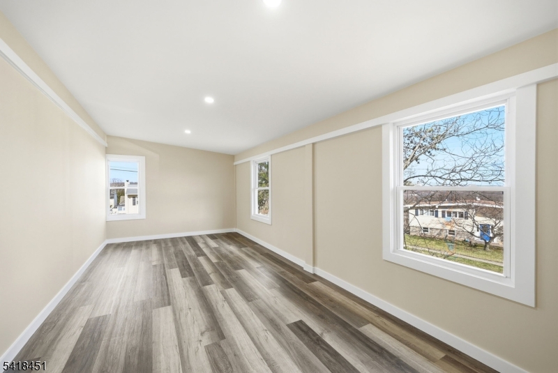 61 Hemlock Road Rockaway, NJ 07866 - Photo 10 of 40 a view of an empty room with wooden floor and a window