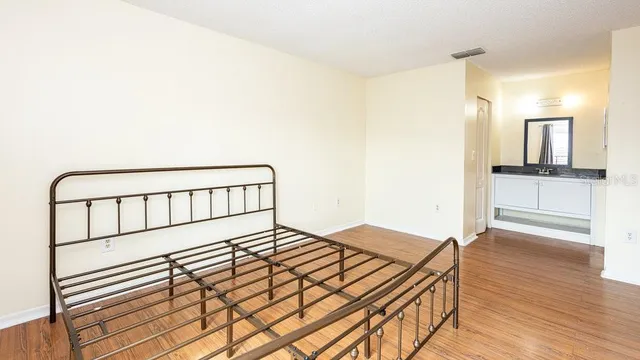 a bedroom with a bed and a view of bathroom