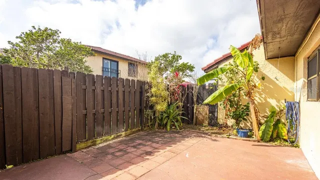 a view of a backyard with wooden fence
