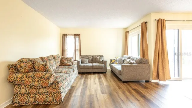a living room with furniture and a large window