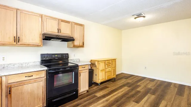a kitchen with stainless steel appliances a stove and a microwave