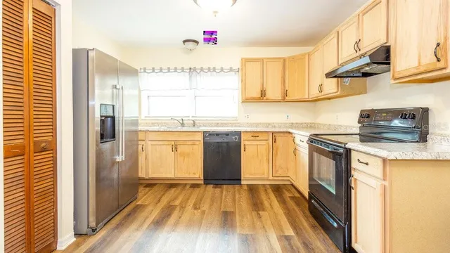 a kitchen with a sink stove and cabinets