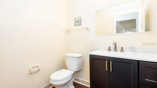 a bathroom with a toilet a sink and mirror