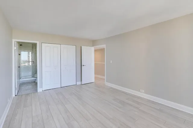 a view of an empty room with wooden floor