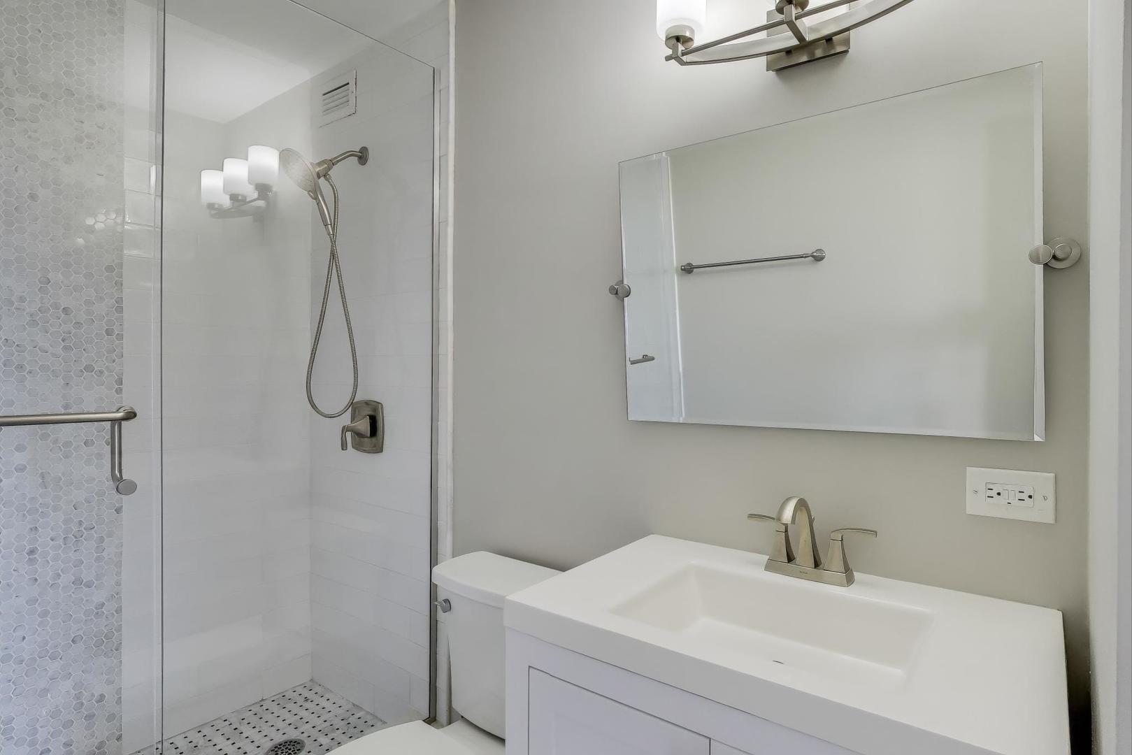1400 North State Parkway, Unit 18A Chicago, IL 60610 - Photo 14 of 31 a bathroom with a sink and a mirror