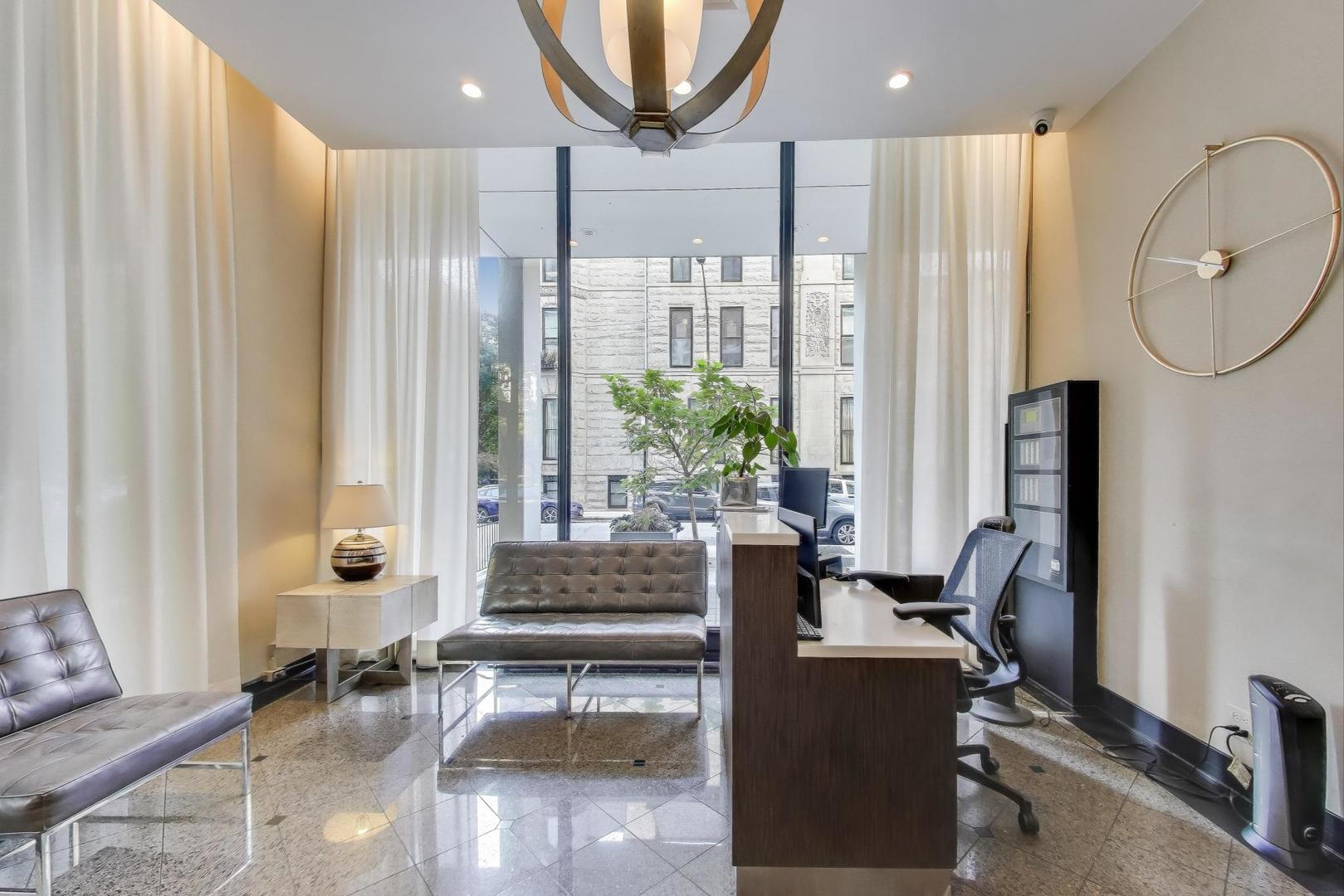 1400 North State Parkway, Unit 18A Chicago, IL 60610 - Photo 25 of 31 a living room with furniture a large window and a chandelier