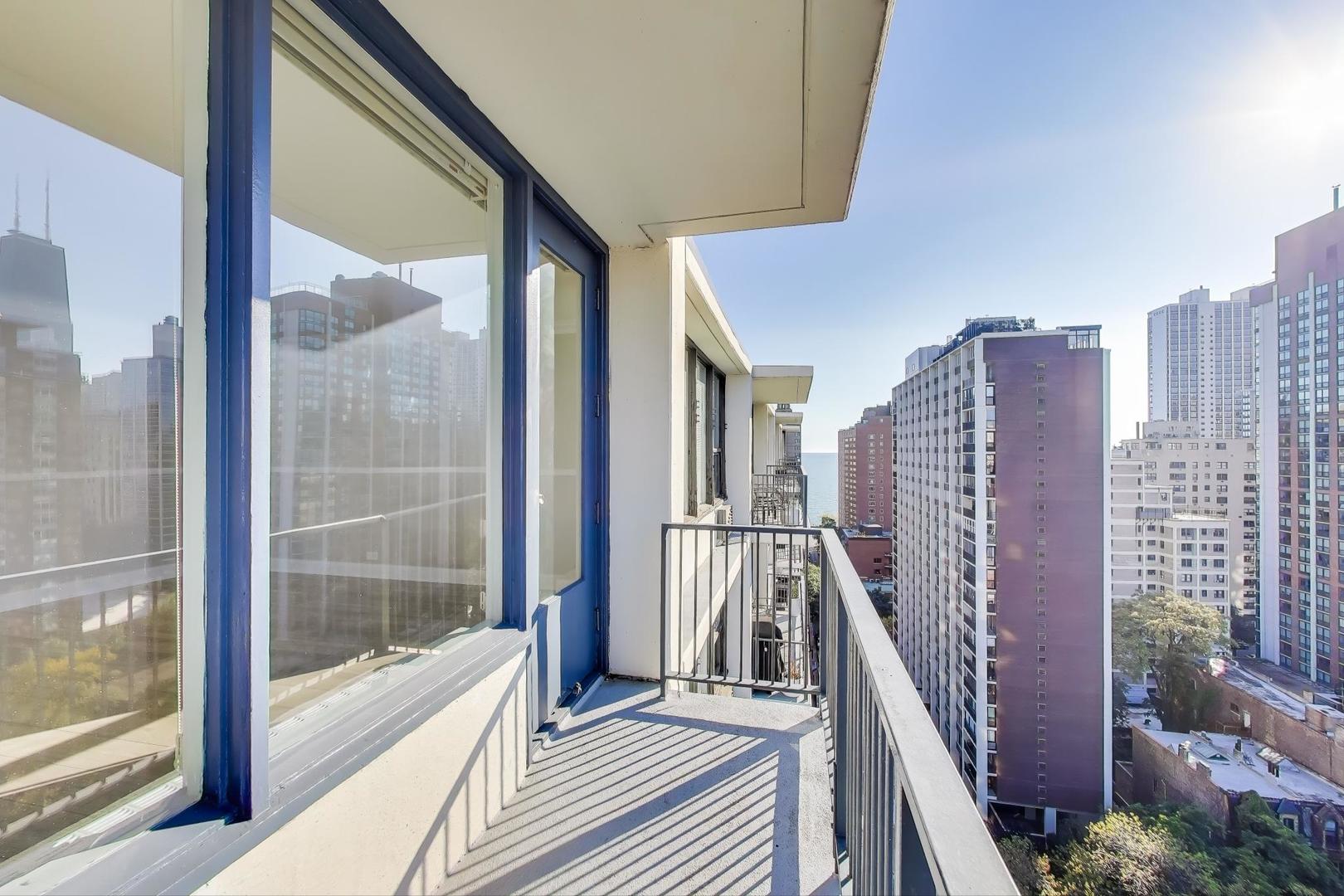 1400 North State Parkway, Unit 18A Chicago, IL 60610 - Photo 6 of 31 a view of a balcony with wooden floor and fence