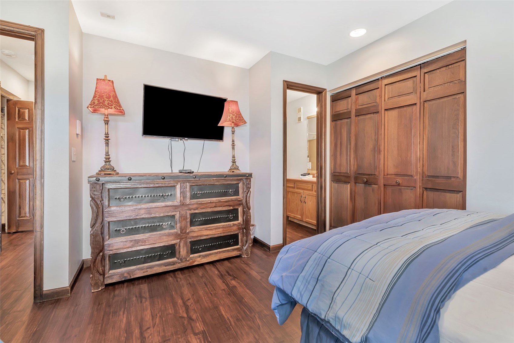 1720 Ranch Road, Unit 309 Steamboat Springs, CO 80487 - Photo 24 of 43 a bedroom with a bed and flat screen tv