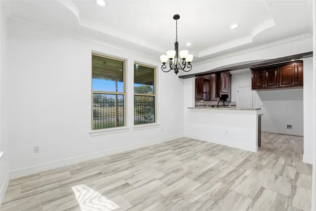 a view of a kitchen with a sink dishwasher a stove and a microwave oven