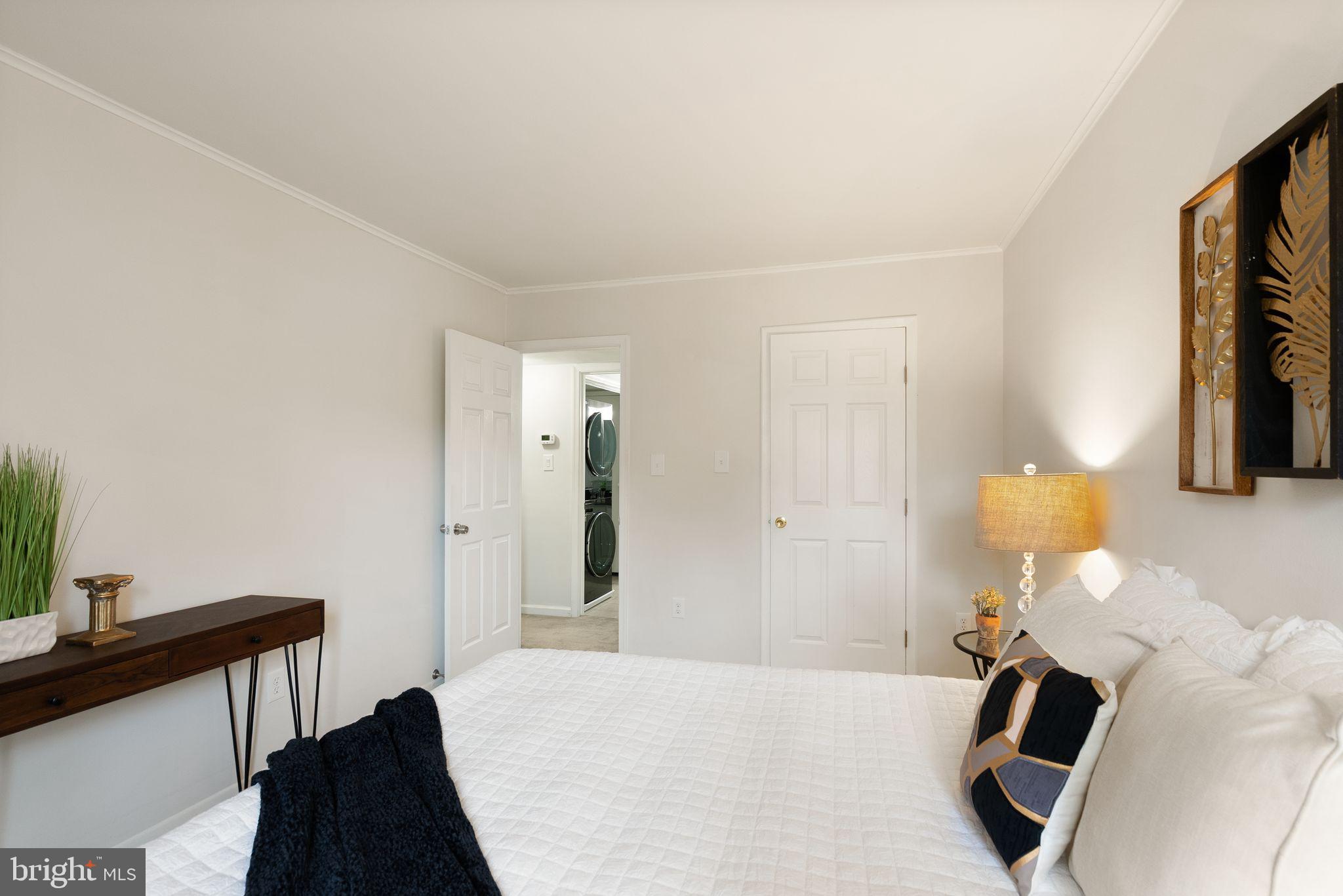 8511 Barrington Court, Unit S Springfield, VA 22152 - Photo 15 of 29 a bedroom with a bed and a chandelier