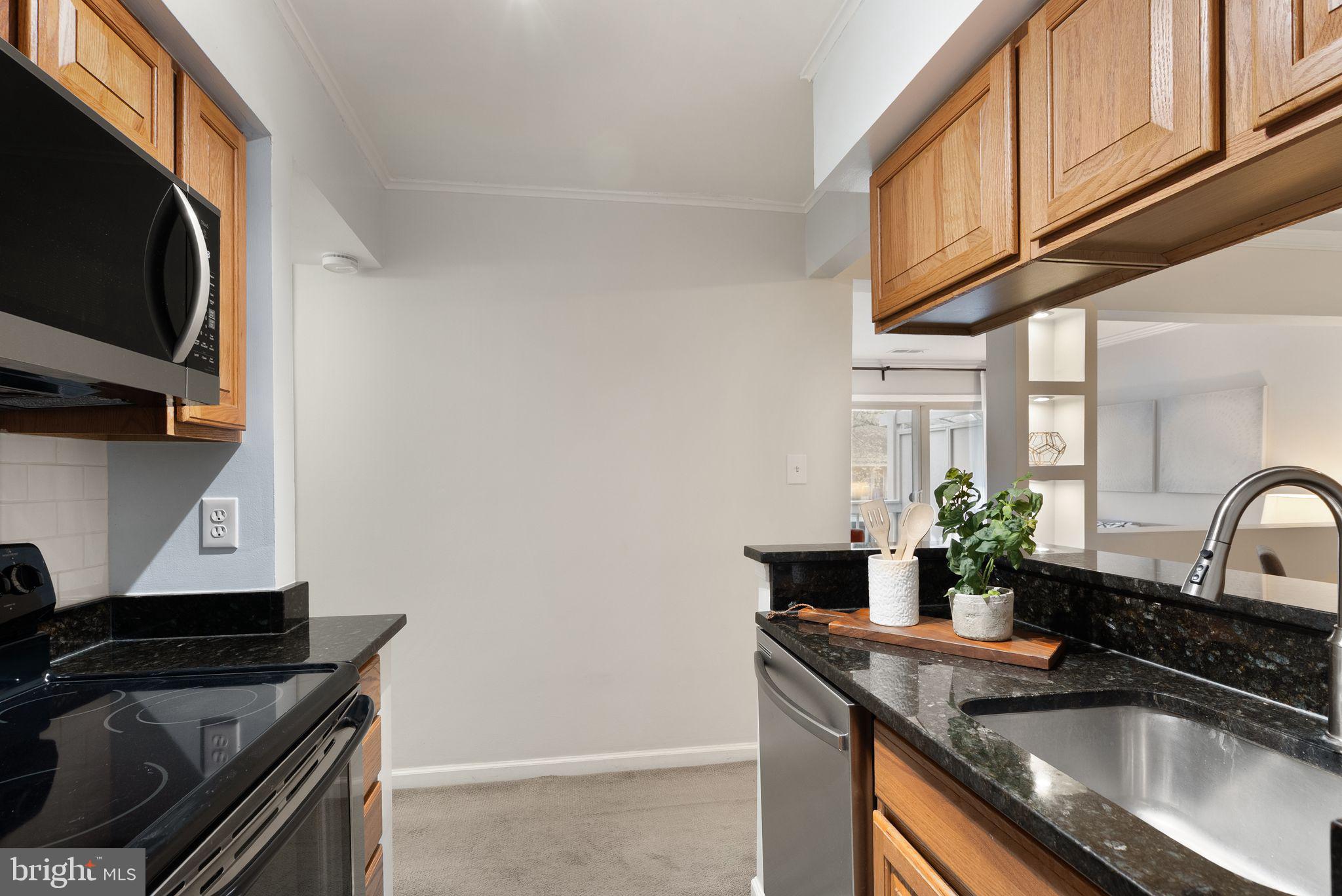 8511 Barrington Court, Unit S Springfield, VA 22152 - Photo 24 of 29 a kitchen with granite countertop a sink a stove and cabinets
