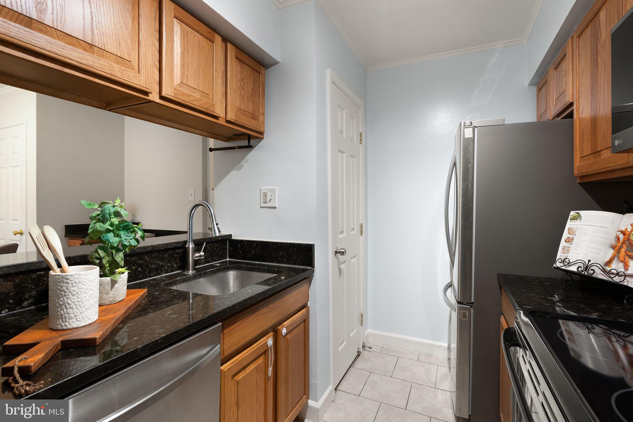 8511 Barrington Court, Unit S Springfield, VA 22152 - Photo 27 of 29 a kitchen with stainless steel appliances granite countertop a sink refrigerator and cabinets