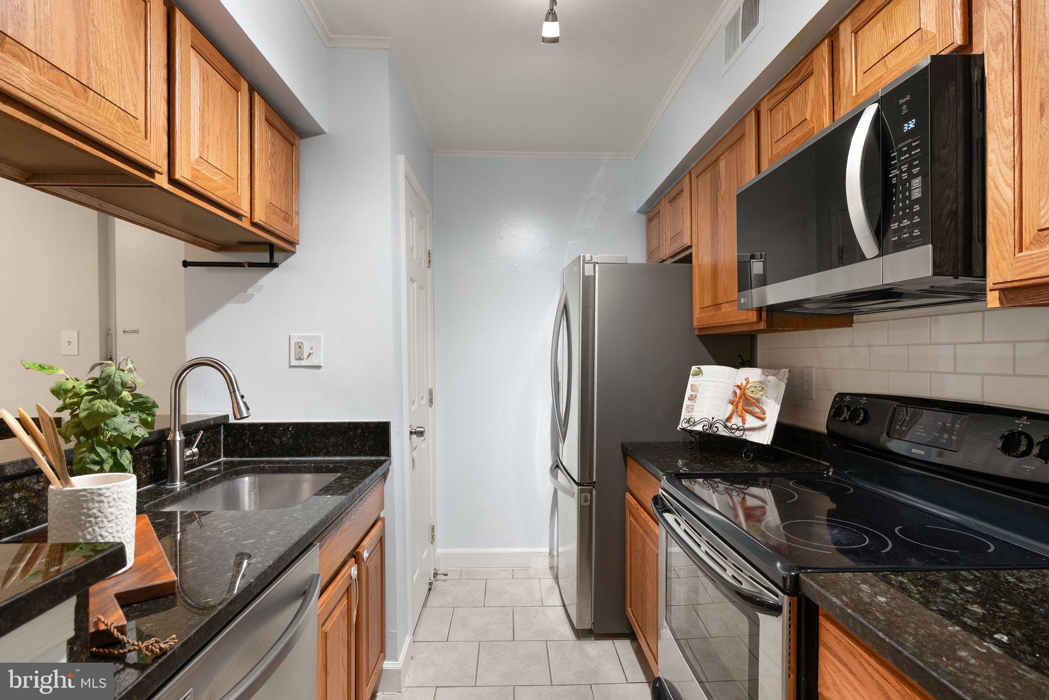 8511 Barrington Court, Unit S Springfield, VA 22152 - Photo 28 of 29 a kitchen with a sink stove and refrigerator