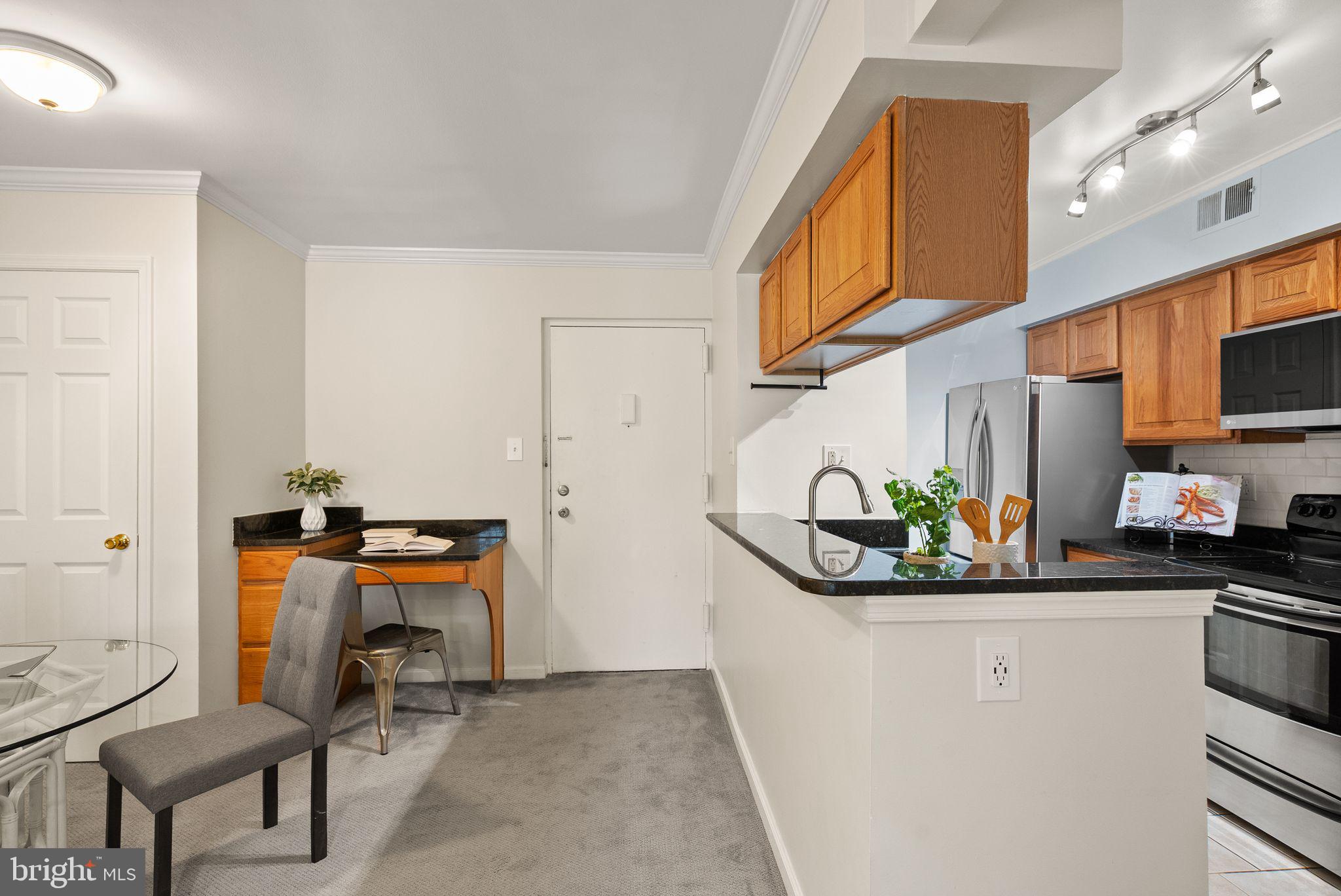 8511 Barrington Court, Unit S Springfield, VA 22152 - Photo 29 of 29 a kitchen with stainless steel appliances granite countertop a sink and a refrigerator