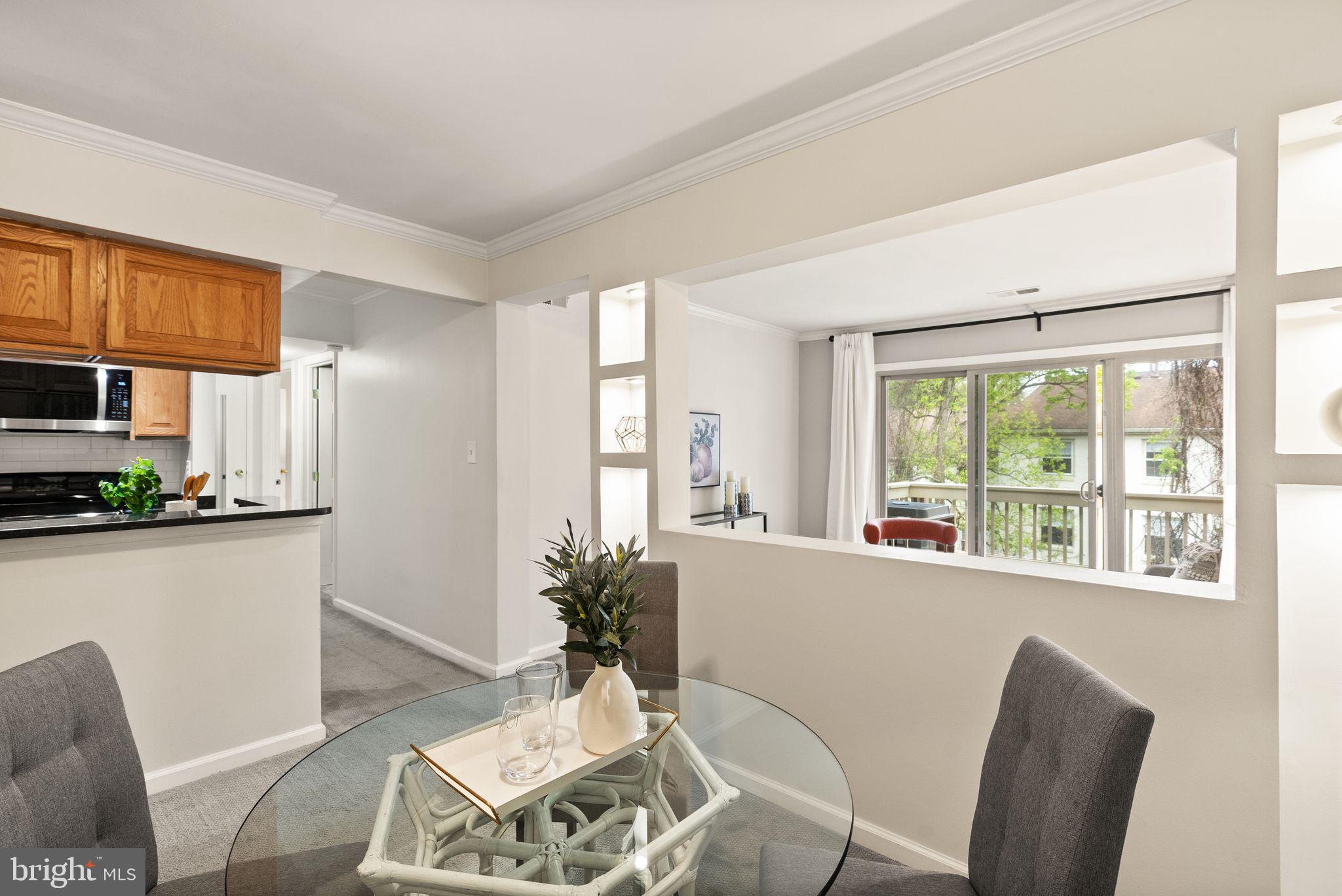 8511 Barrington Court, Unit S Springfield, VA 22152 - Photo 6 of 29 a living room with furniture a large window and kitchen view