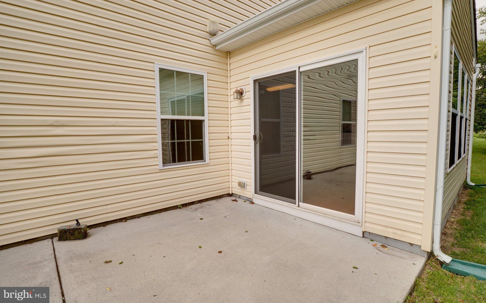 192 Bobbys Branch Road Millsboro, DE 19966 - Photo 38 of 49 Backyard patio looking into sunroom