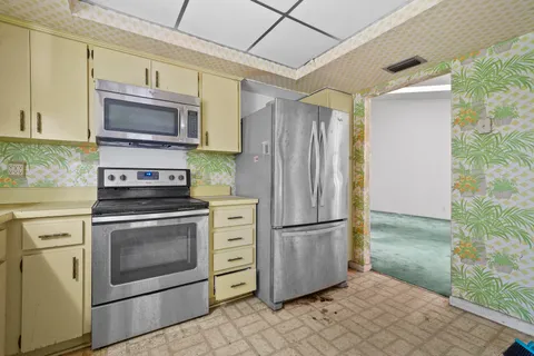 a kitchen with a refrigerator stove and microwave