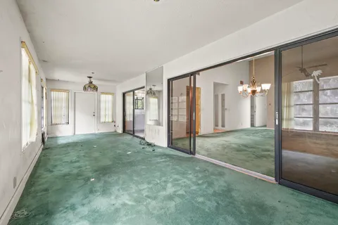 a view of livingroom with hardwood floor and front door