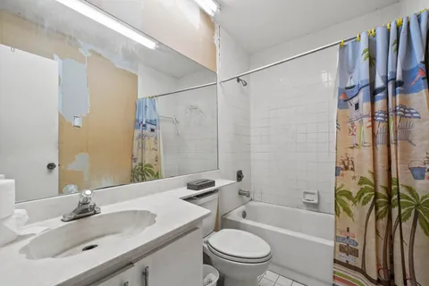a bathroom with a sink a toilet a bathtub and shower