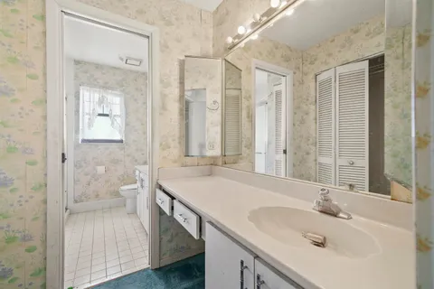 a bathroom with a tub sink and mirror