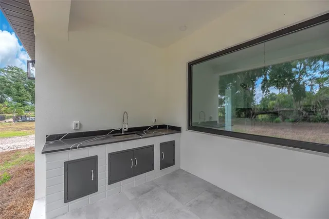 a view of an empty room with a fireplace and a large window