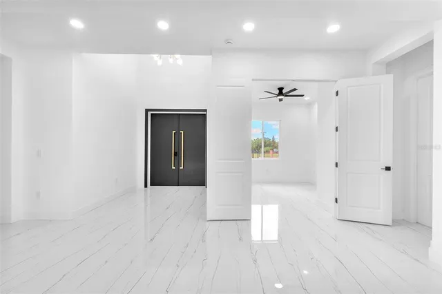 a view of a living room and kitchen with furniture appliances