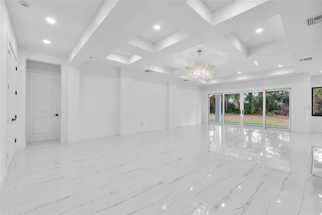 a large white kitchen with a large window
