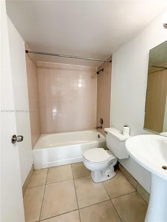 a bathroom with a bathtub a toilet a sink and mirror