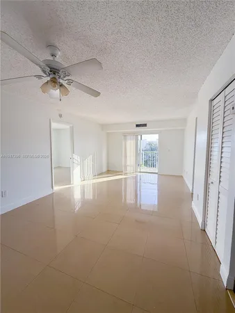 a view of a livingroom with a ceiling fan and window