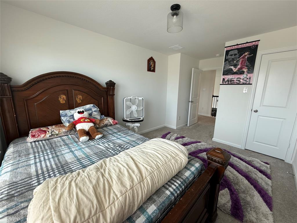 2006 Placerville Street Forney, TX 75126 - Photo 29 of 35 Carpeted bedroom with a clear glass flush mount ceiling light fixture, white interior doors, and neutral wall paint