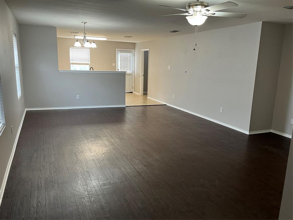 849 Santa Rosa Drive Fort Worth, TX 76052 - Photo 2 of 16 an empty room with wooden floor and windows