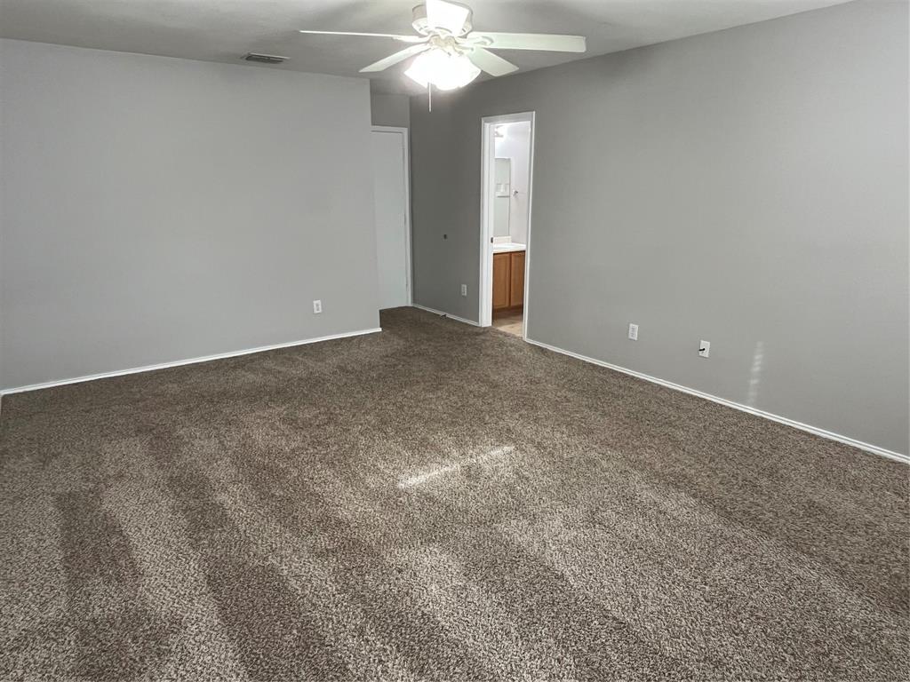 849 Santa Rosa Drive Fort Worth, TX 76052 - Photo 5 of 16 a view of an empty room with a chandelier fan