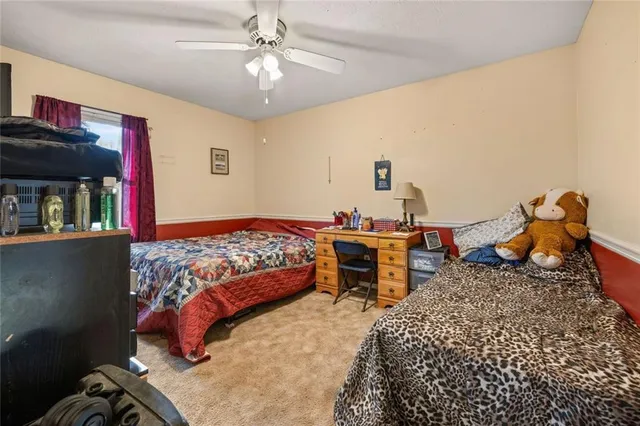 a bedroom with bed and a chandelier